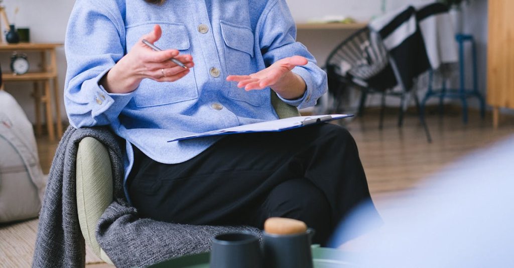 A therapist consults with a client in a contemporary office, focusing on mental health.